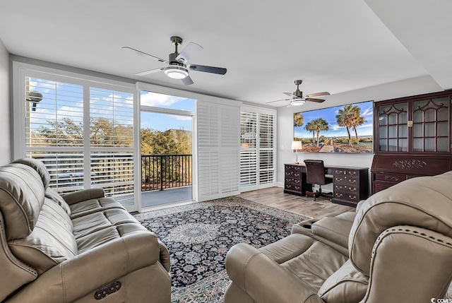 living room featuring light wood-type flooring and ceiling fan