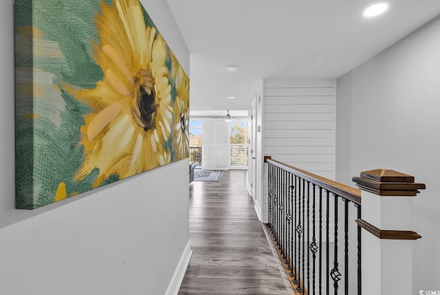 hallway with hardwood / wood-style floors