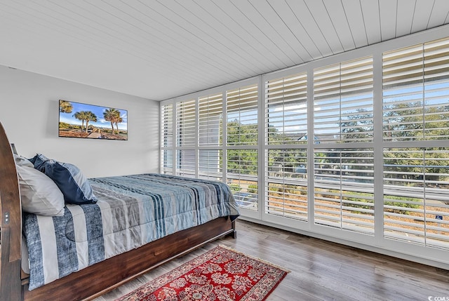 bedroom featuring wood ceiling and wood-type flooring