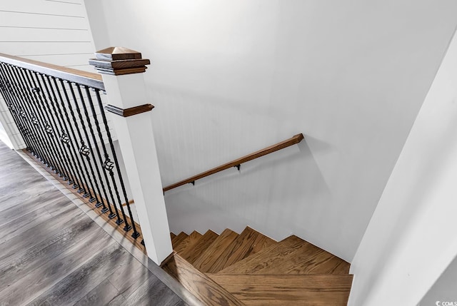 stairs featuring wood-type flooring