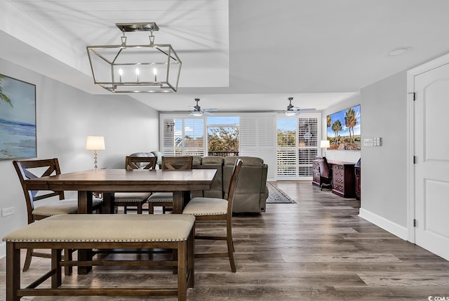 dining room featuring a notable chandelier and dark wood-type flooring