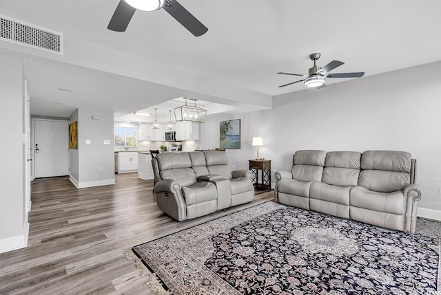 living room with hardwood / wood-style flooring and ceiling fan