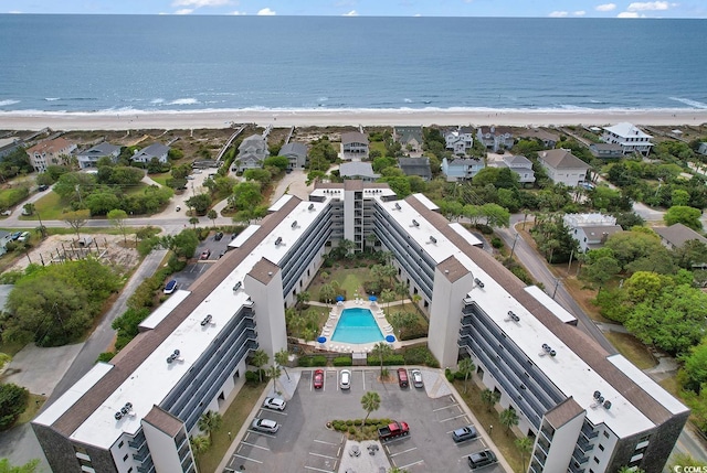 bird's eye view featuring a water view and a beach view