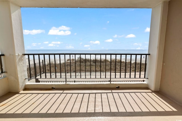 balcony with a view of the beach and a water view