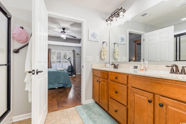 bathroom with ceiling fan, tile patterned flooring, and vanity