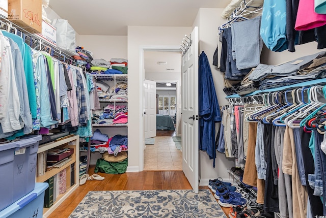 walk in closet with hardwood / wood-style flooring