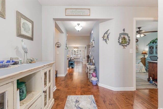 hall with dark wood-type flooring