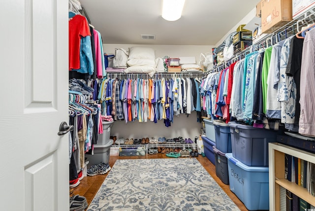 walk in closet with hardwood / wood-style floors