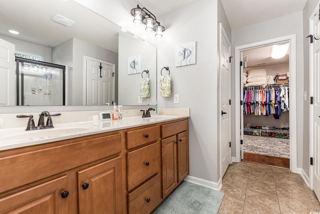 bathroom with vanity, tile patterned floors, and walk in shower