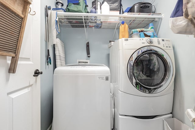 clothes washing area with separate washer and dryer