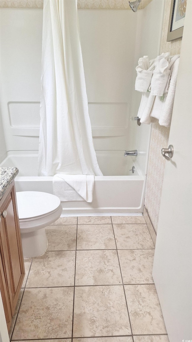 full bathroom featuring tile patterned floors, toilet, vanity, and shower / bath combination with curtain