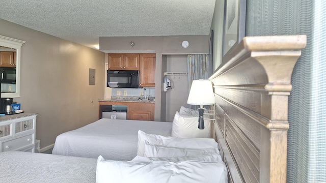 bedroom featuring sink and a textured ceiling