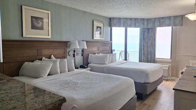 2700 N Ocean Blvd Unit 1854, Myrtle Beach, SC 29577 - bedroom with multiple windows, light wood finished floors, and a textured ceiling