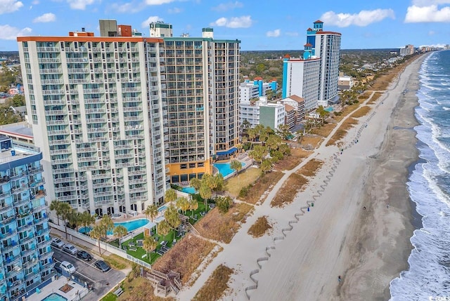 birds eye view of property with a water view and a view of the beach