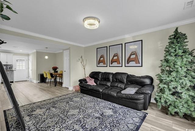 living room with light hardwood / wood-style floors and ornamental molding