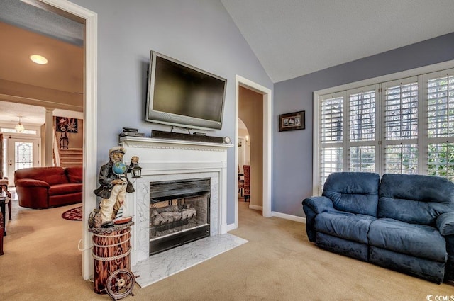 carpeted living room featuring vaulted ceiling and a wealth of natural light