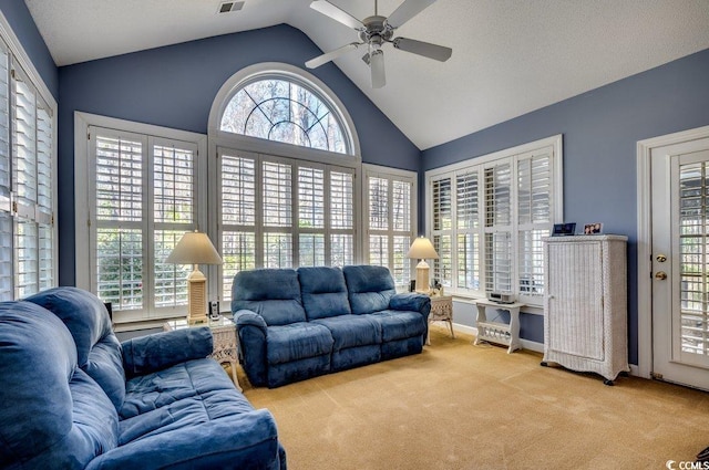 living room featuring lofted ceiling, ceiling fan, and carpet flooring