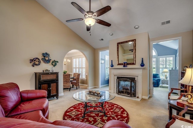 living room with a fireplace, light colored carpet, and a wealth of natural light