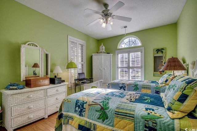 bedroom with light wood-type flooring and a textured ceiling