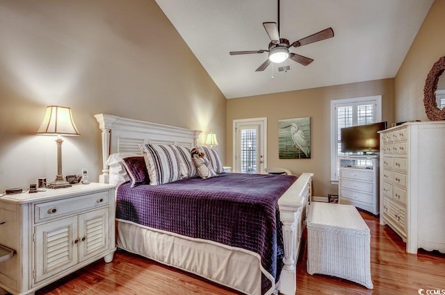 bedroom with vaulted ceiling and light hardwood / wood-style flooring