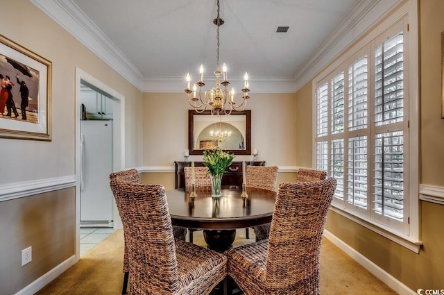 carpeted dining room featuring a baseboard radiator, crown molding, and a chandelier