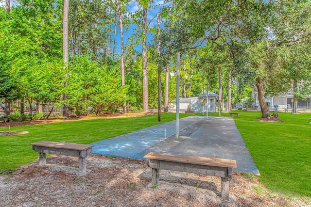 view of home's community with shuffleboard and a lawn