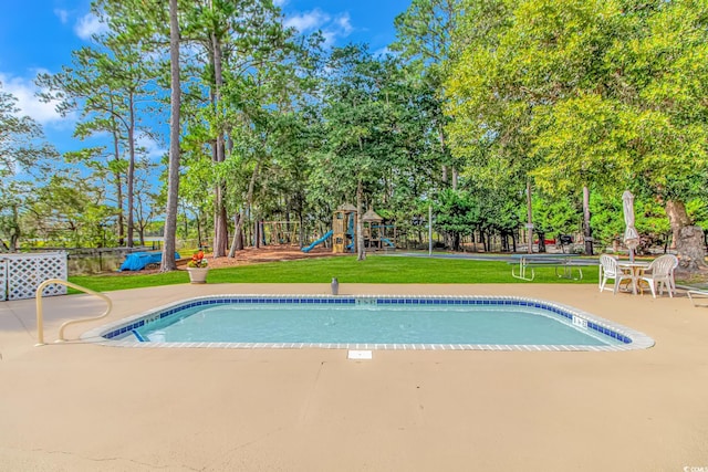 view of pool with a fenced in pool, a lawn, a patio, fence, and a playground