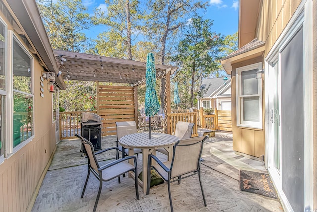 view of patio / terrace with a grill, fence, a pergola, and outdoor dining space