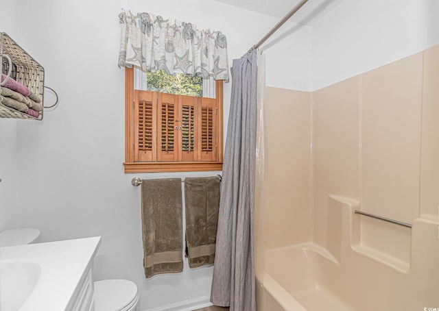 bathroom with vanity, toilet, and shower / bath combo with shower curtain