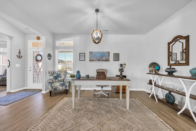 office with wood finished floors, visible vents, and baseboards