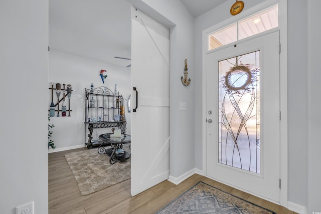 entrance foyer with wood finished floors and baseboards