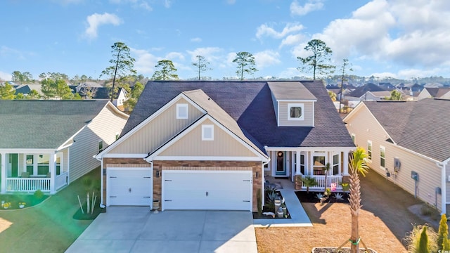 view of front facade featuring a residential view, a porch, concrete driveway, and a garage