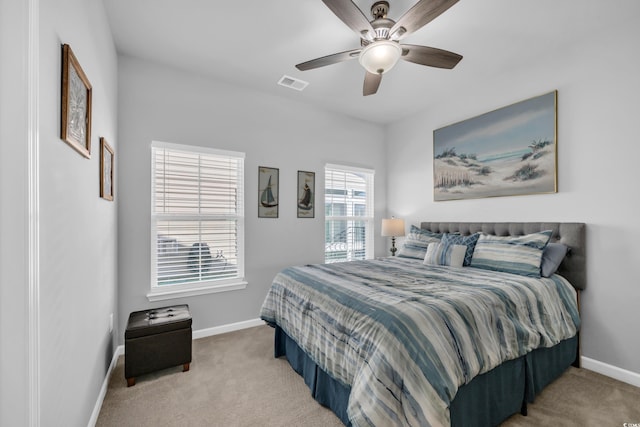 carpeted bedroom featuring visible vents, baseboards, and ceiling fan