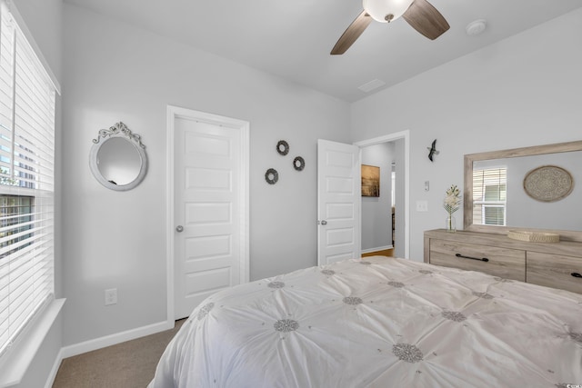 carpeted bedroom featuring visible vents, a ceiling fan, and baseboards