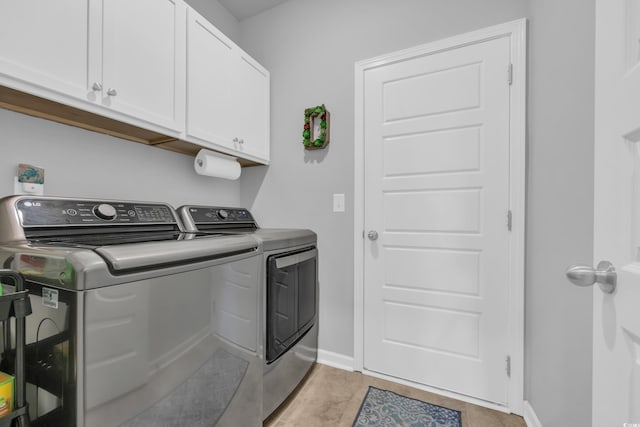 laundry room with washer and dryer, baseboards, and cabinet space