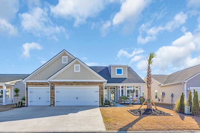 view of front of property with stone siding, driveway, an attached garage, and a shingled roof