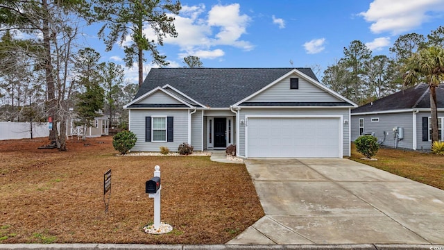 view of front of house with a front yard, concrete driveway, roof with shingles, and an attached garage