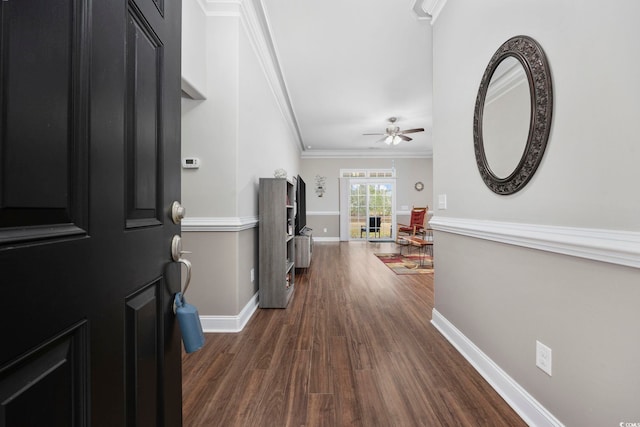 entryway featuring ceiling fan, baseboards, dark wood finished floors, and crown molding