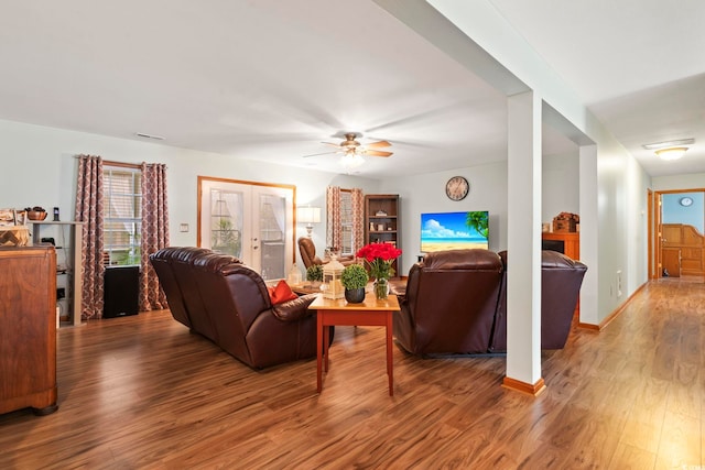 living area featuring ceiling fan, french doors, wood finished floors, and baseboards