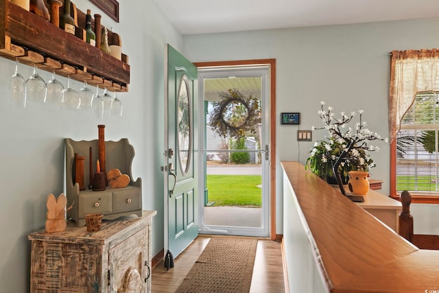 doorway to outside with a healthy amount of sunlight and wood finished floors