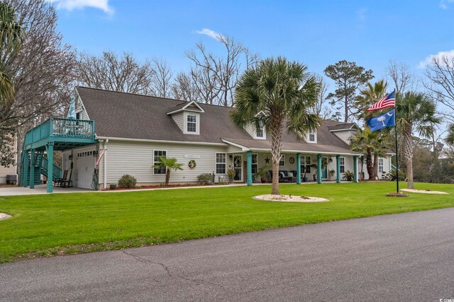 view of front of house with an attached garage, a shingled roof, a front lawn, and concrete driveway