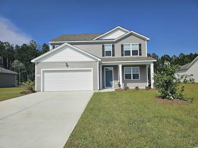 view of front of house featuring a garage, driveway, and a front lawn