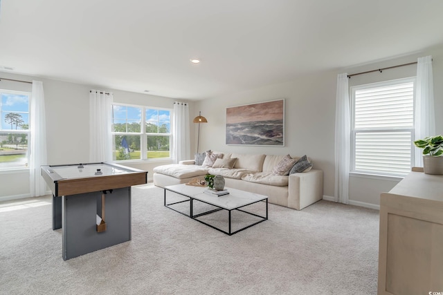 living area featuring recessed lighting, light carpet, and baseboards