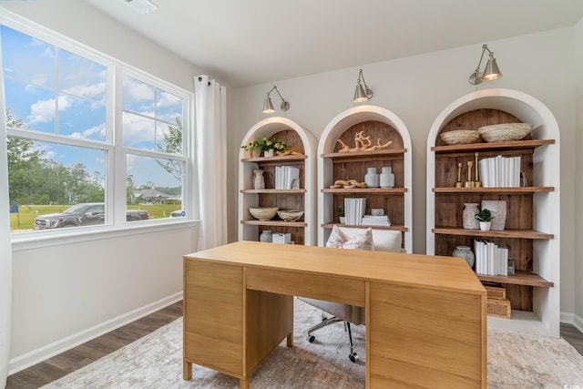 office space with baseboards and wood finished floors