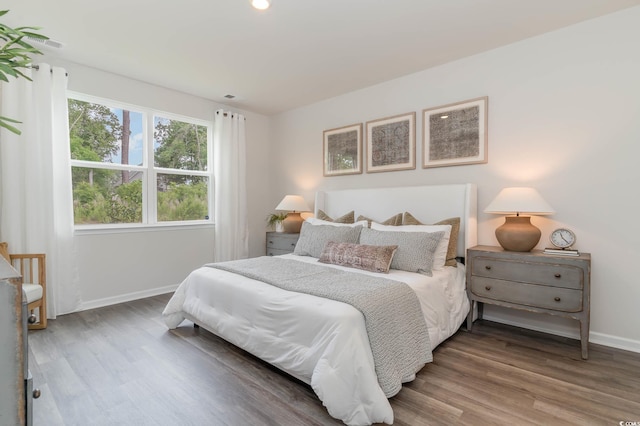 bedroom with baseboards and wood finished floors