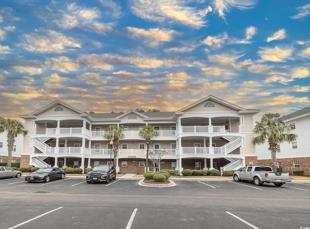 6015 Catalina Dr Unit 734, North Myrtle Beach, SC 29582 - property at dusk with stairway and uncovered parking