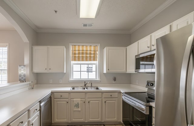 6015 Catalina Dr Unit 734, North Myrtle Beach, SC 29582 - kitchen featuring stainless steel appliances, a sink, arched walkways, white cabinets, and crown molding