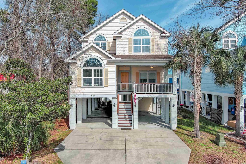720 Melody Ln, Surfside Beach, SC 29575 - coastal home with covered porch and a carport