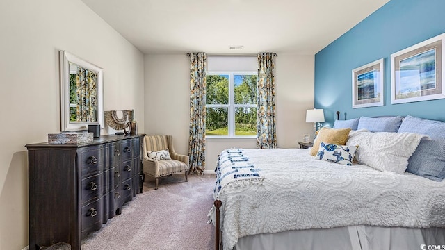 bedroom featuring visible vents, baseboards, and carpet