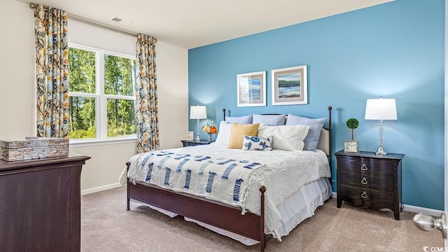 carpeted bedroom featuring visible vents and baseboards